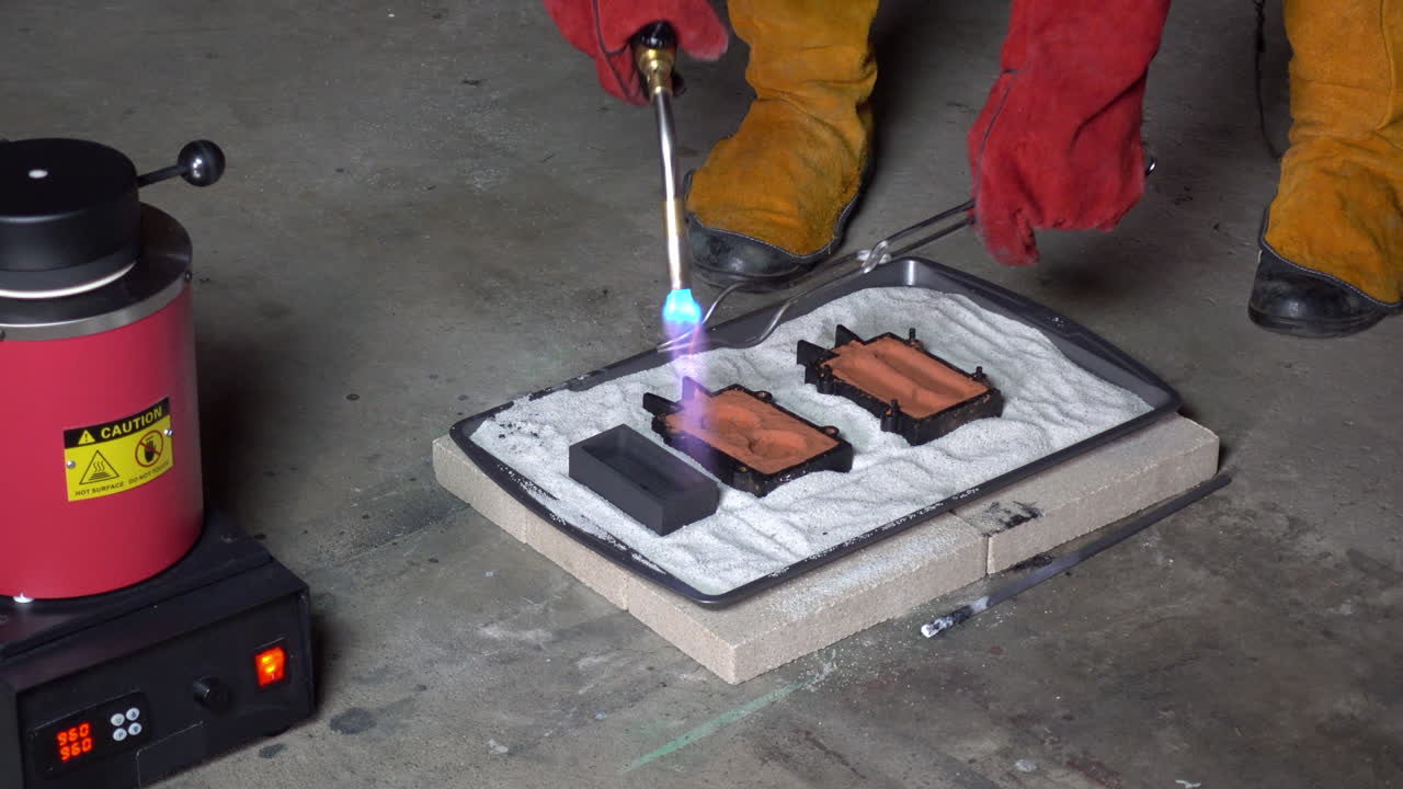 Metal tongs and metal casting molds are heated prior to pouring molten metal