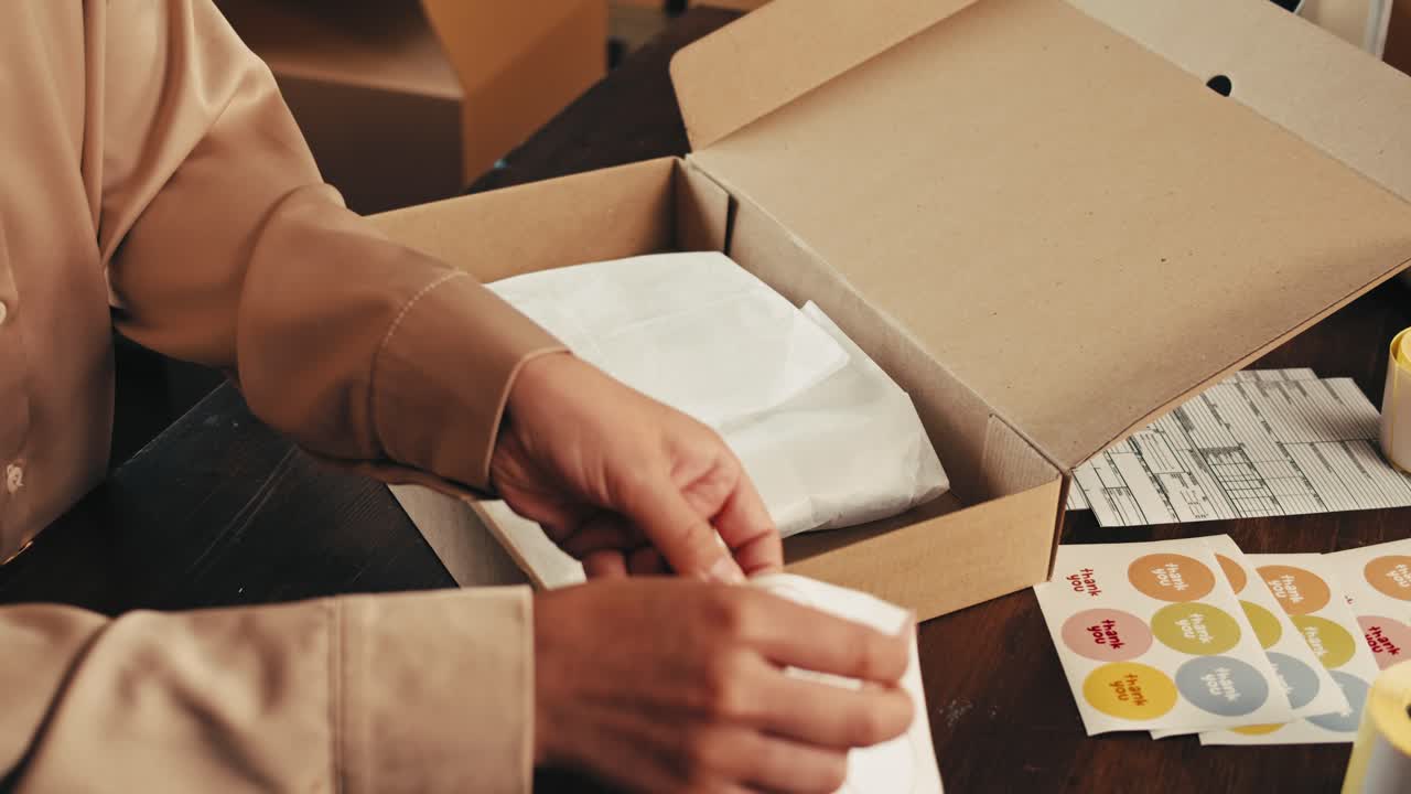 E-commerce storage shop, woman packing goods and clothes for second hand delivery market, dedicated Packaging and Shipping Workspace with Supplies and Technology for efficiency, online sales.