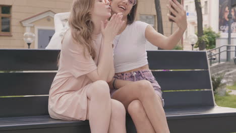 two young women taking a selfie in a park