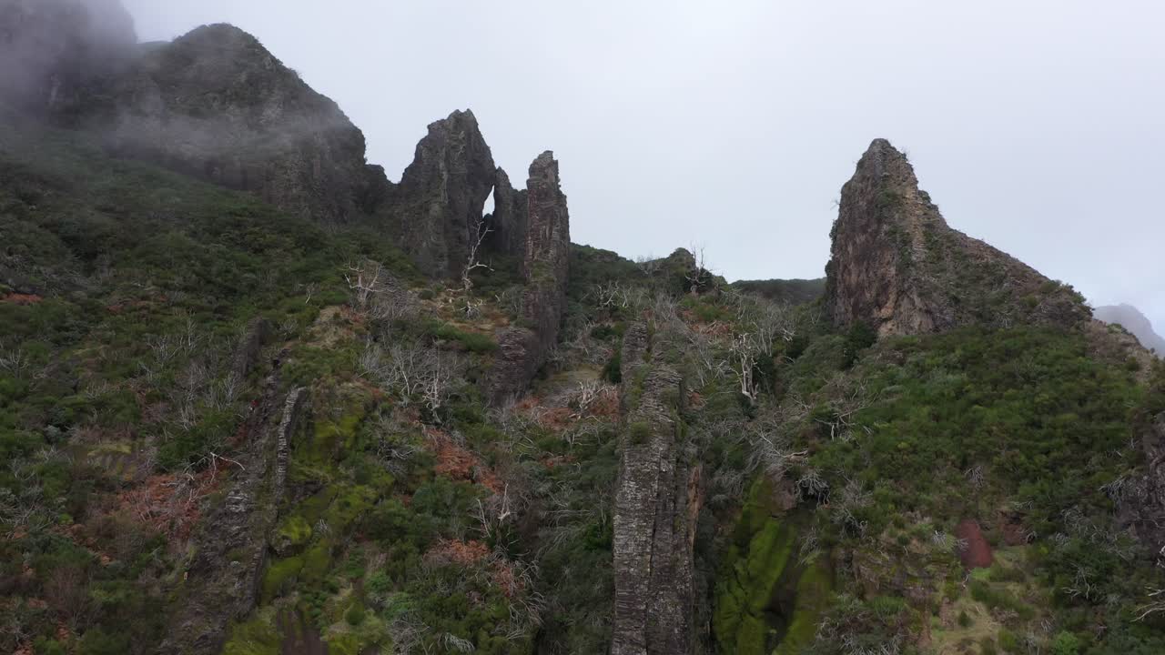 Drone shot moving down along the steep cliffs of Nuns Valley in Madeira.