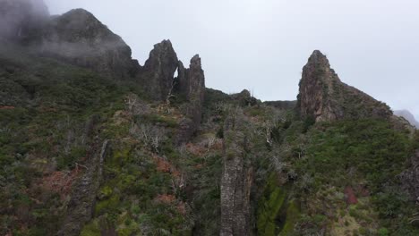 drone shot moving down along the steep cliffs of nuns valley in madeira.