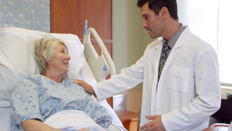 doctor talks to senior patient in hospital bed shot on r3d