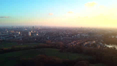 Aerial-view-of-sunset-over-Hampstead-Heath-Park-in-North-London,-UK