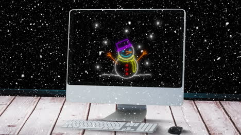 Animation of snowman on computer over snow falling at christmas