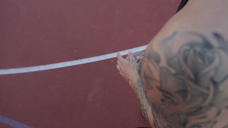 basketball player on a court with a tattoo