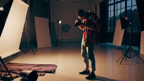 photographer in a colorful shirt shooting in a studio