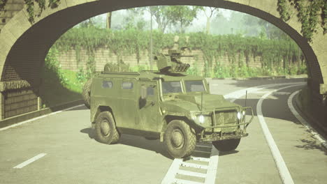 military vehicle maneuvers under an archway in a serene landscape