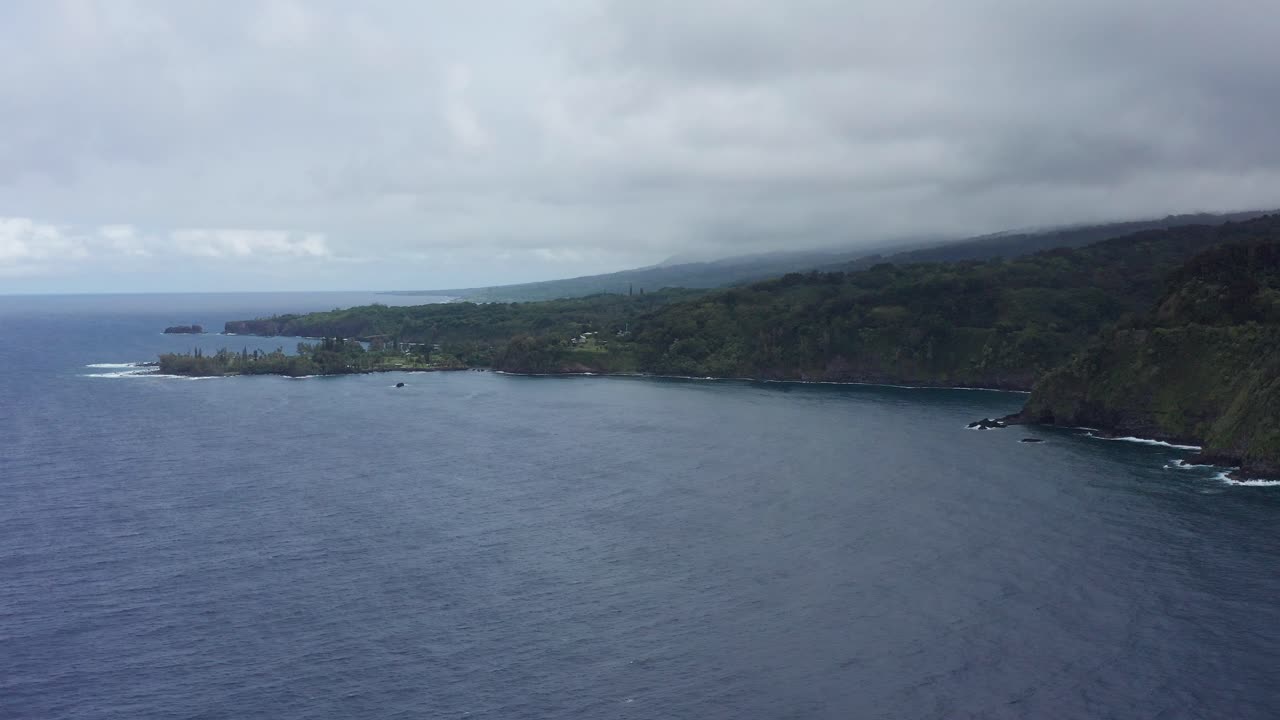 Aerial wide panning shot of the rugged coastline along the Road to Hana in Maui, Hawai'i