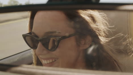 woman driving a convertible on a sunny day