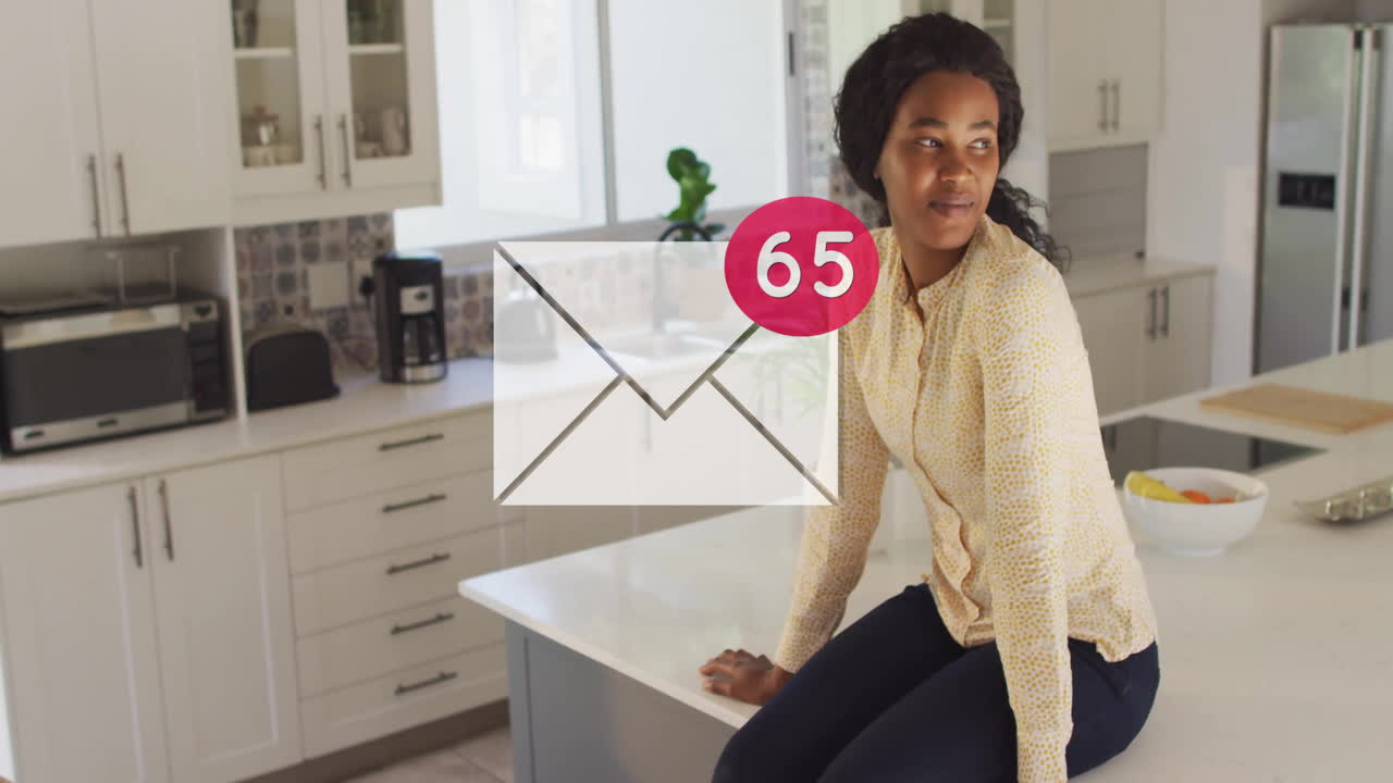 Woman sitting on kitchen counter with email notification animation over her