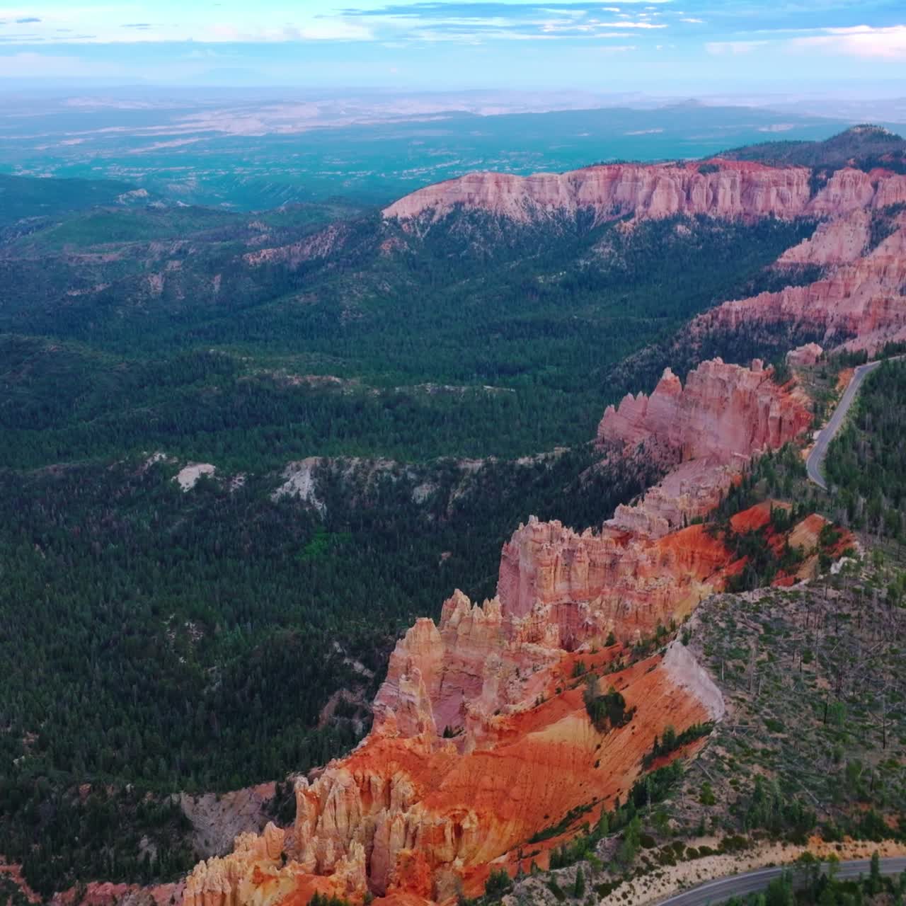 Amazing blue skies over the mountainous landscape overgrown with green pine trees. Highway going by the tops of wonderful canyons in Zion National Park, Utah, USA