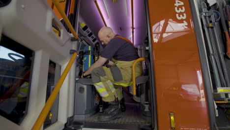 firefighter checking their breathing apparatus inside the fire truck