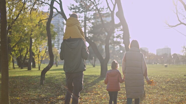 Family walking in the park during autumn