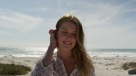 Young-woman-standing-at-beach-on-a-sunny-day-4k