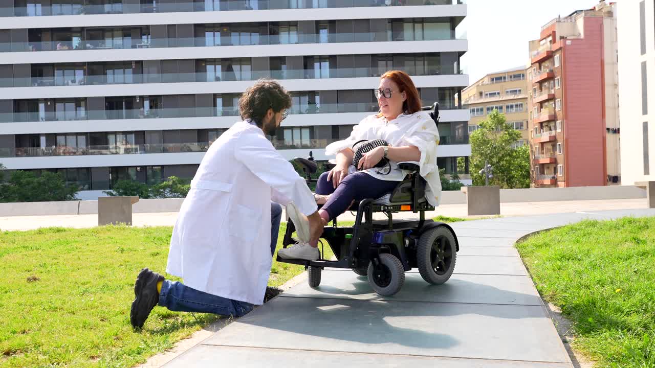 Medical Professional Assisting a Patient in a Wheelchair