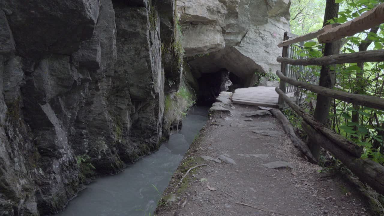 Part of a walking trail next to an irrigation canal carrying water used for agricultural purposes.