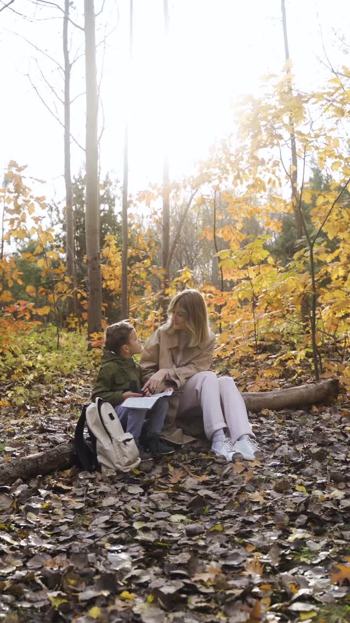 Mother and son sitting at the forest