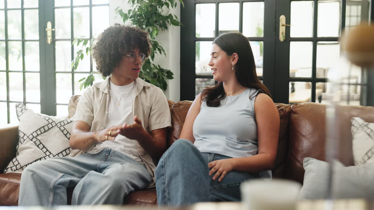 Young Man and Woman Having a Casual Conversation on a Couch