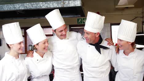 group of chefs standing together with arms around