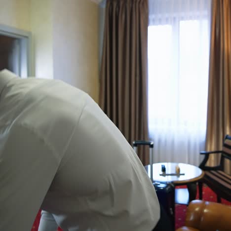 handsome man in a hotel room. young businessman arrived into the hotel and sitting on a sofa after a tiring journey