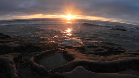 waves roll on to a beach just after sunset 2