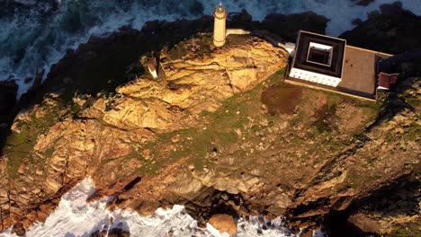 drone fly over cabo vilan galicia north spain lighthouse over top cliff rock formation golden hour drone footage