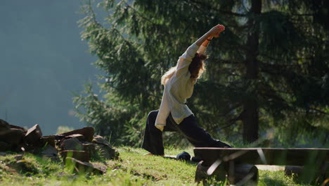 Yoga-woman-having-workout-outdoors.-Carefree-girl-doing-exercises-on-green-hill.
