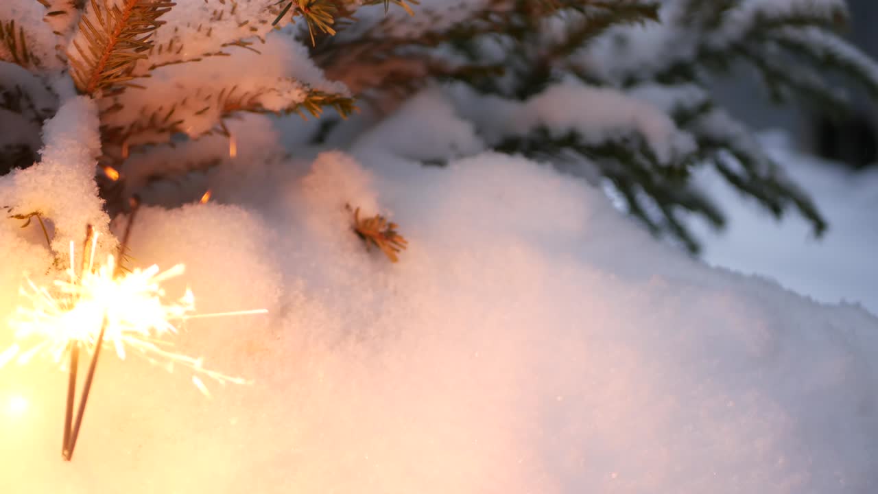 Christmas tree in snow, sparkler firework burning, New Year or Xmas bengal light