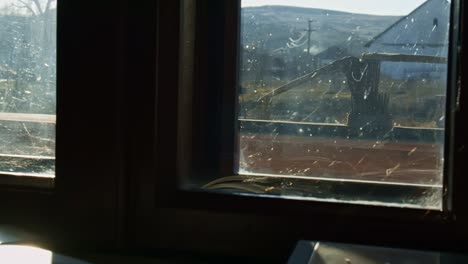 in an old house, in an old village in romania, the sun shines trhough the window on a photobook that keeps so meny memories