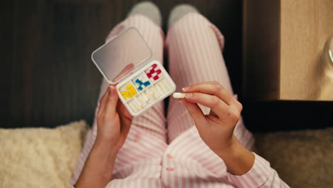 woman taking medication in pajamas