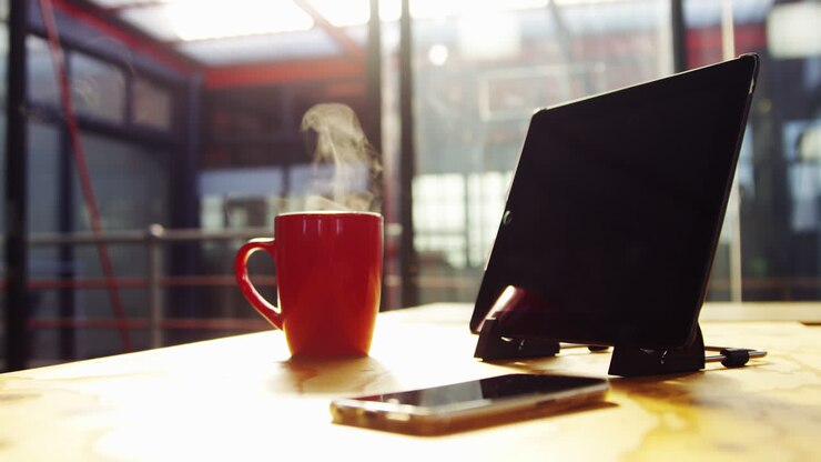 Tablet digitale, telefono cellulare e tazza di caffè sulla scrivania
