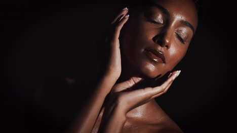 portrait of a woman with glossy skin in the dark