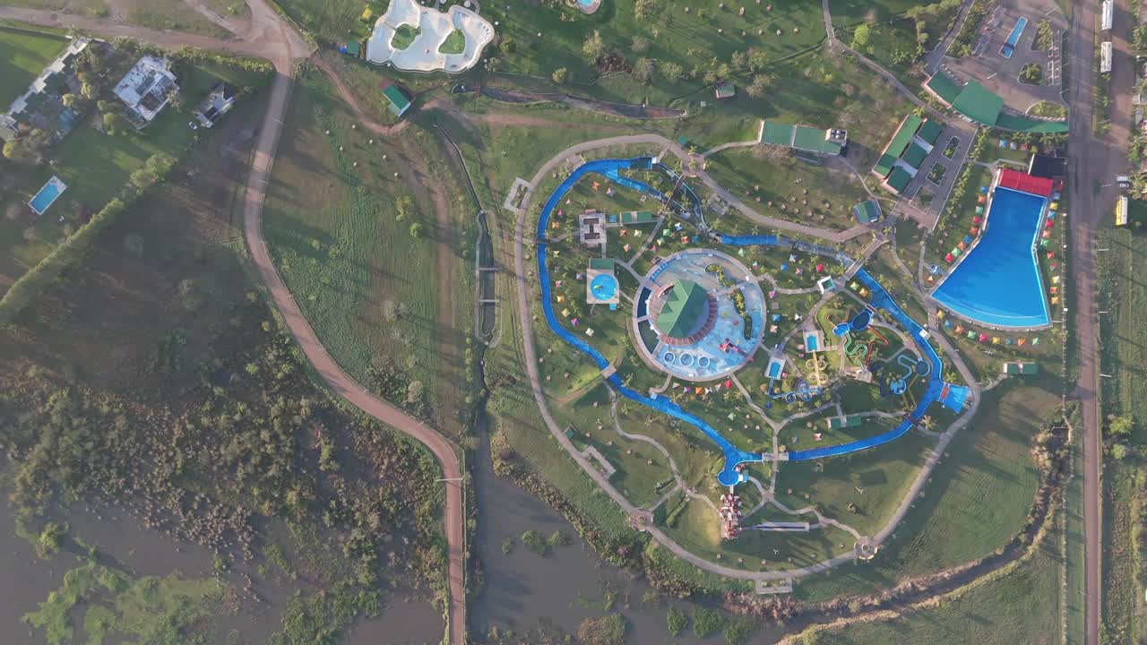 Drone overhead shot capturing the panoramic view of federacion city in entre rios province, argentina, showcasing its renowned thermal resorts and lush green surroundings