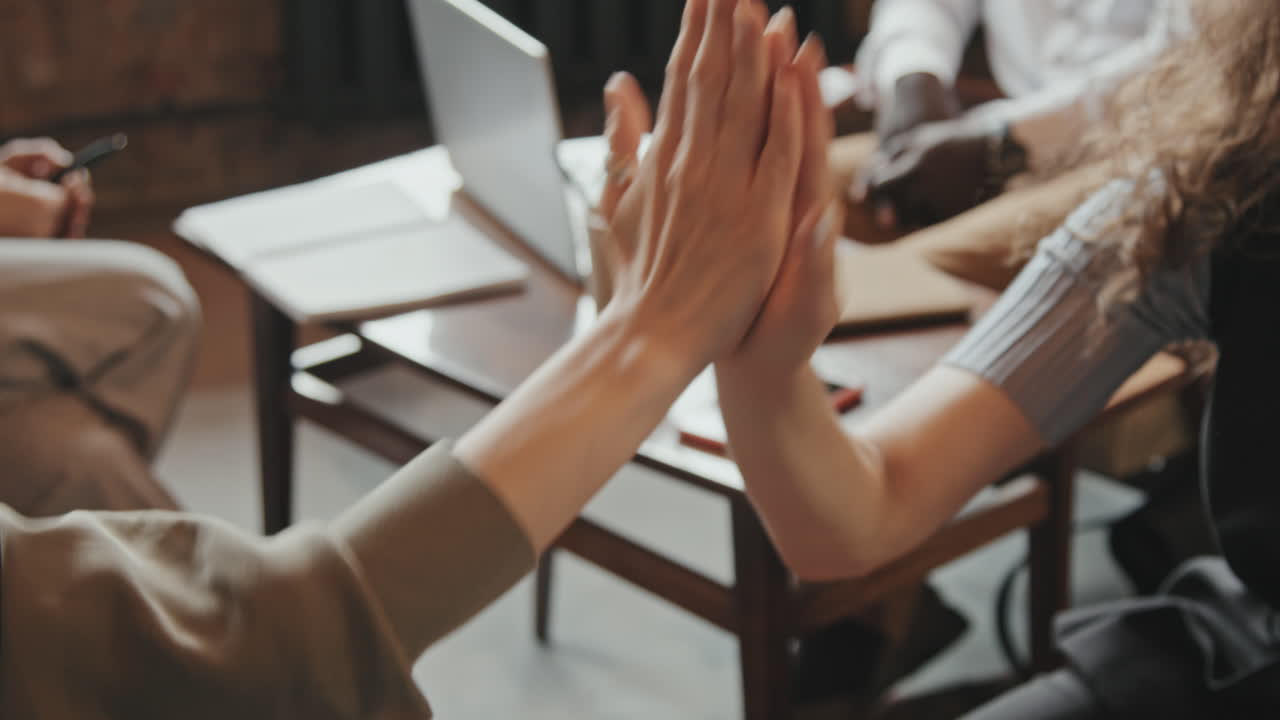 Close-Up of Coworkers Giving High-Fives
