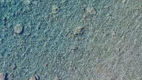Aerial-Drone-Top-Down-View-Reflection-Texture-in-Shallow-Ocean-Water-Rocks-Sand