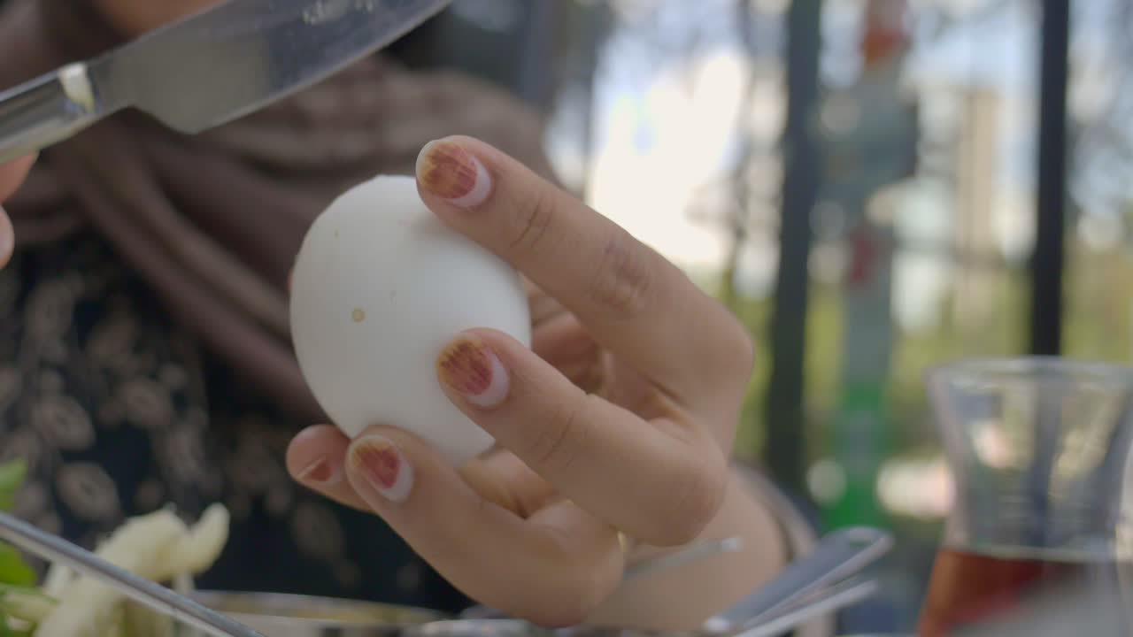 Close-up of a Person Cutting an Egg