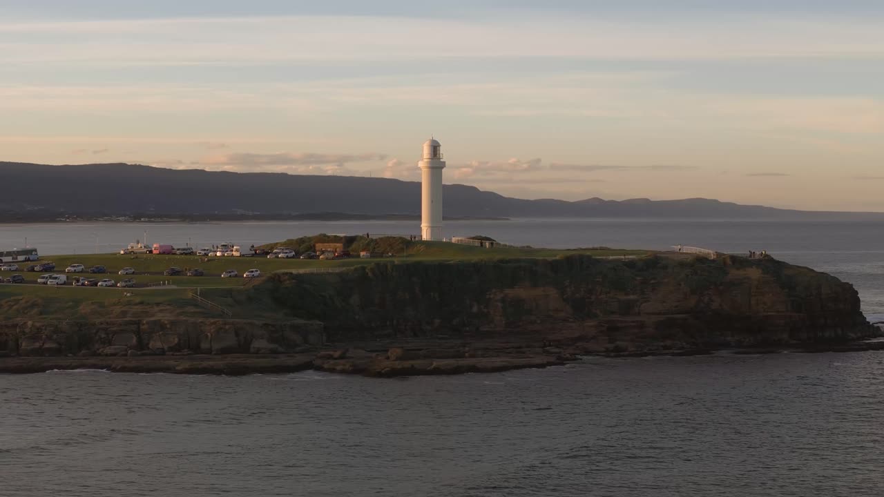 Aerial of Wollongong’s iconic lighthouse and surrounding coastal city during sunrise in New South Wales, Australia