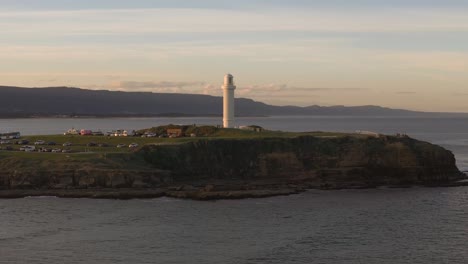 aerial of wollongong’s iconic lighthouse and surrounding coastal city during sunrise in new south wales, australia