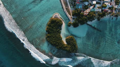 green-island-with-white-sand-beach-waves-and-blue-lagoon