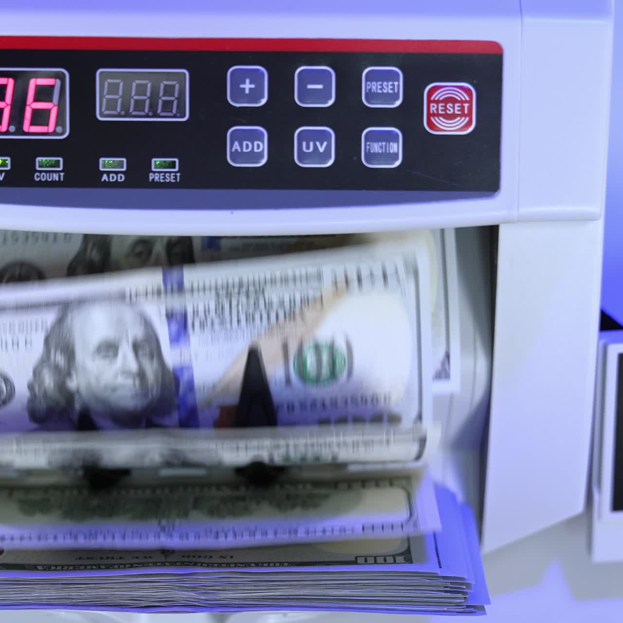 Money counting equipment for paper money calculation. Automatic mechanism for bank financial operations. Currency exchange of one hundred dollars. Close-up