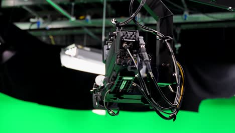 film crew in green studio shooting video. chroma - technology of combining two or more images or frames in single composition. cameraman, director, crew. filmmaking industry.