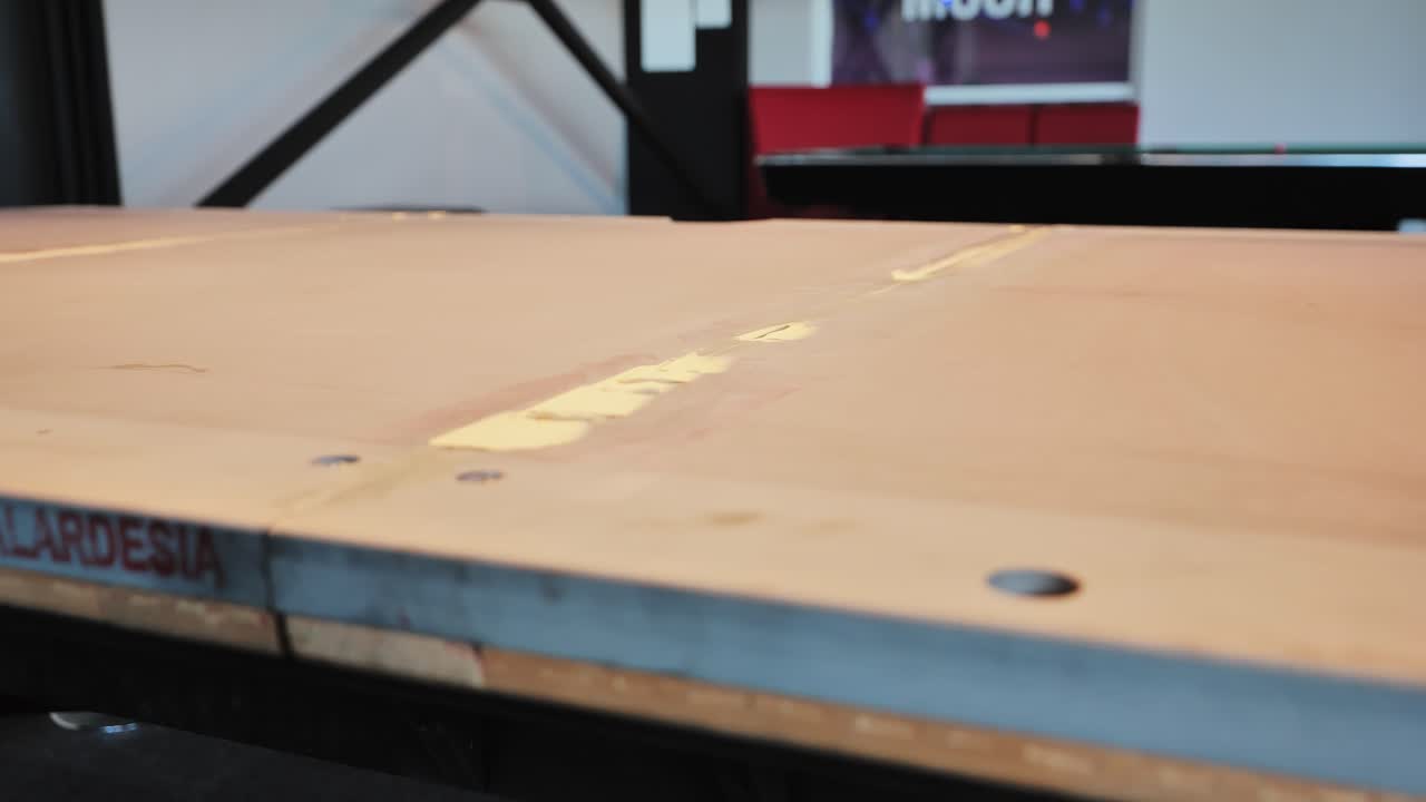 Artisan reviews putty line between slate panels in indoor pool table assembly