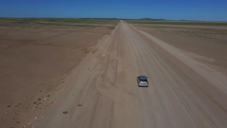 Drone shot of the Namib-Naukluft National Park in Namibia - drone is overtaking a car in the beautiful steppe. Snippet could ideally be used for travel or nature related movies or Namibia videos.