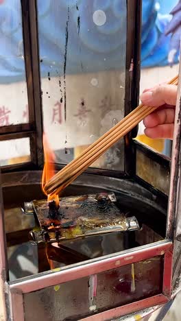 incense lighting ritual in chonburi, thailand