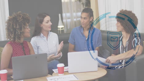 colleagues discussing email security in office lounge with laptops showcasing shield icon