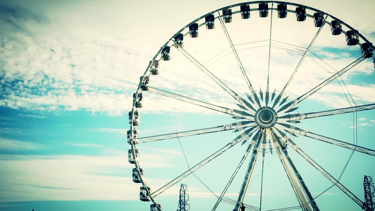 Ruota panoramica in stile vintage che ruota lentamente contro il cielo blu