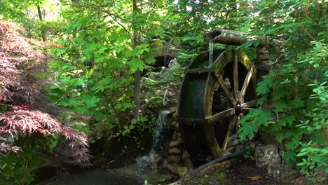 an old water mill cycling water from a cold mountain stream