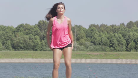 woman stretching outdoors by the lake