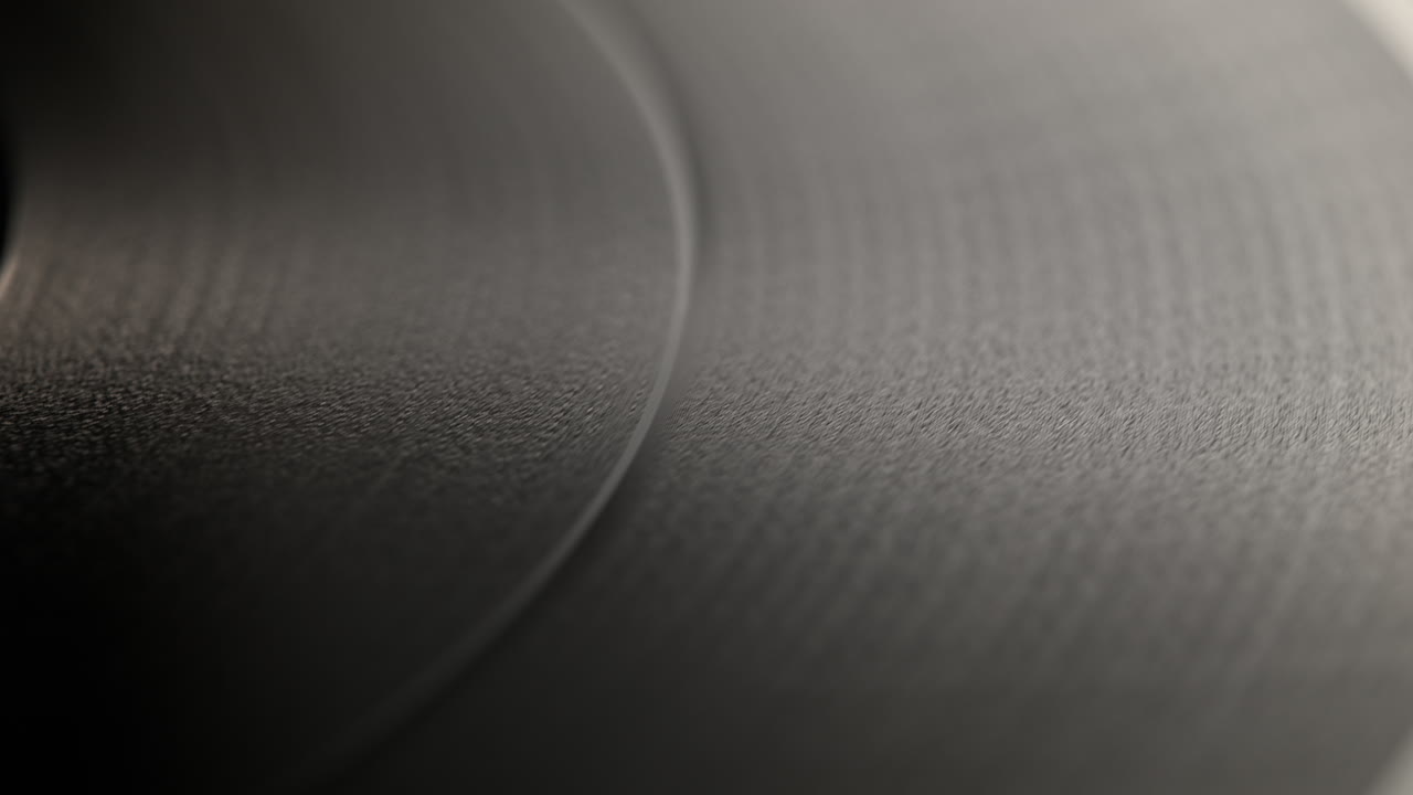 Spinning Vinyl Record - Camera Slides From The Record Label To Its Outer Edge, over the Wooden Table