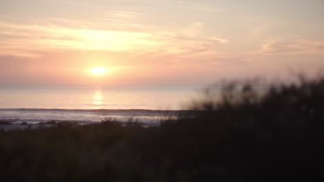sunset casts a warm glow over the ocean horizon, with copy space
